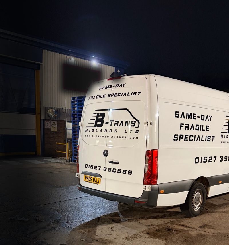A B-Trans van at night with Same-day Fragile Specialist on the door
